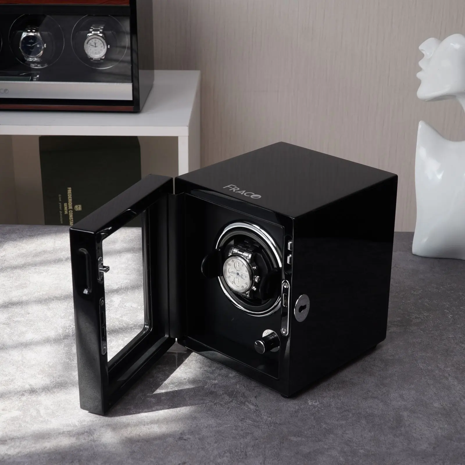 Illustrative luxury wristwatch displayed in a black watch winder (licensed stock photo)